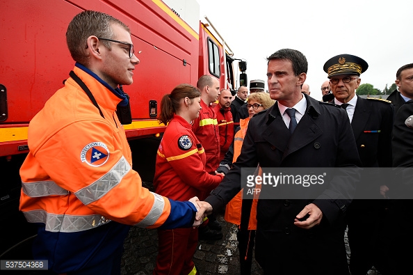 
Thủ tướng thăm hỏi nhân viên phòng cháy chữa cháy tại hiện trường. Ảnh: Lionel Bonaventure / AFP
