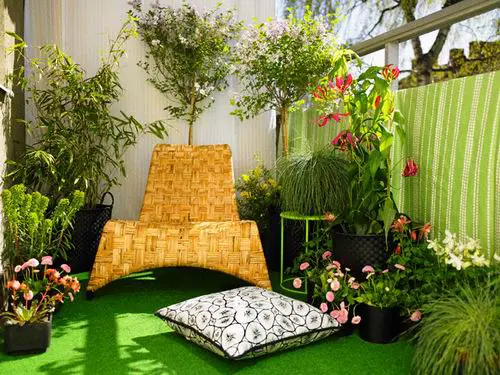 Ý tưởng trang trí ban công bằng thảm màu xanh với cỏ cây hoa lá sẽ mang lại góc thư giãn mát dịu cho gia đình bạn.